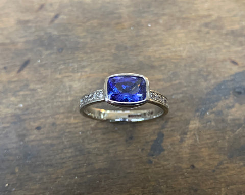 Cushion shaped Tanzanite , Diamonds and 18ct White Gold Ring. Tanzanite of fine mid colour and excellent clarity. 1.92 carats, in collet setting to a parallel band pave set with 10 brilliant cut diamonds, 5 to  each shoulder. G colour, VS1 clarity. Ring is size N middle, and weighs 4.1 grams. The ring is made from high Palladium 18ct white gold o no rhodium plating required. £2600